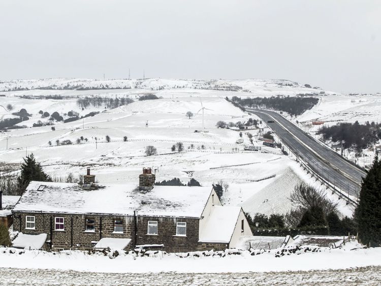 A farm house in the snow next to the M62 in Kirklees