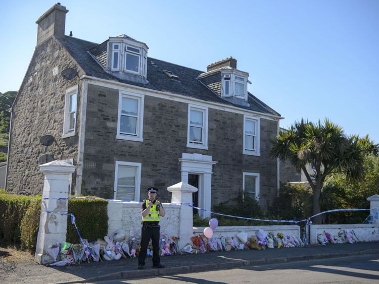 Police stand outside the house that Alesha MacPhail went missing from