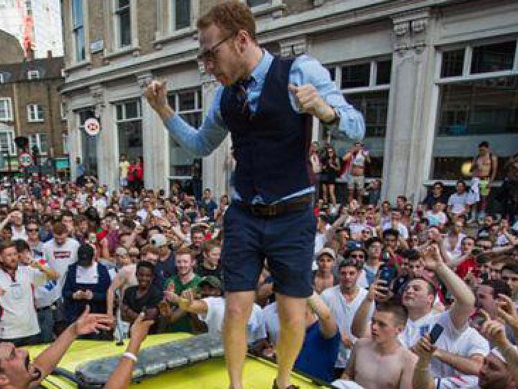 A man wearing a Gareth Southgate style waistcoat was seen on the ambulance roof