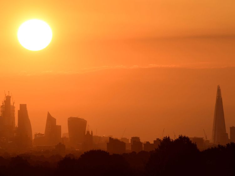 The sun rises behind skyscrapers in the City of London in London, Britain, August 4, 2018. REUTERS/Toby Melville