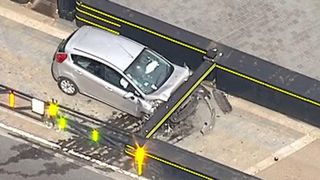 The damage to the front of the car is clearly seen from the air