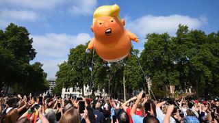 A 'Baby Trump' balloon rises after being inflated in London's Parliament Square