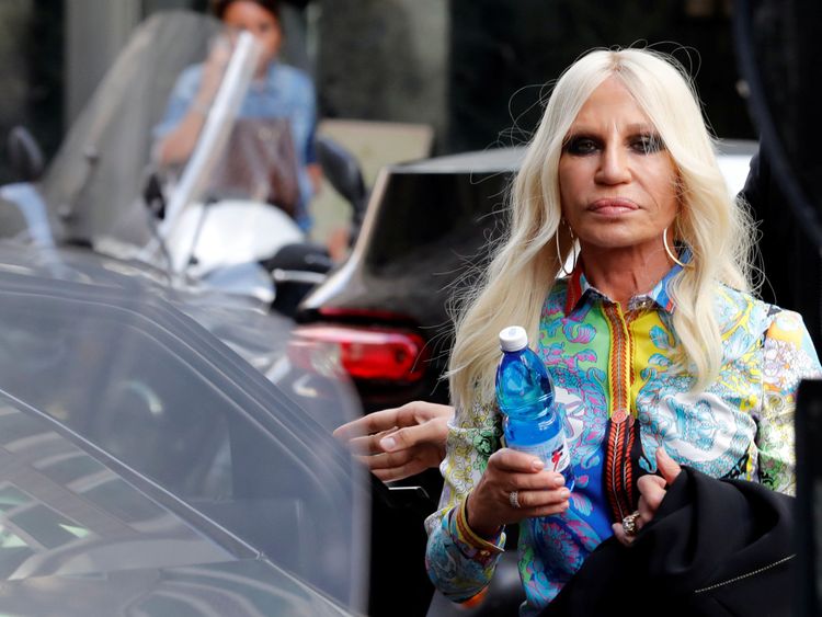 Donatella Versace, in classic Versace print, arriving to announce the news to employees in Milan